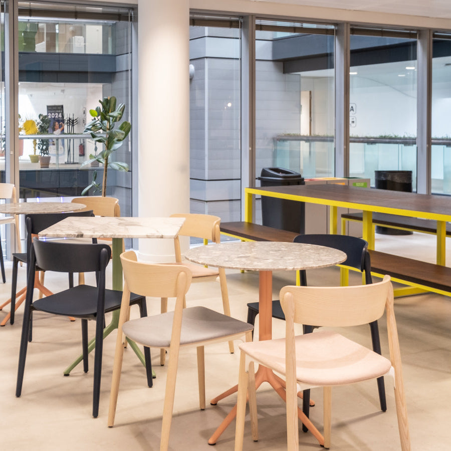 Modern office break room with tables and chairs