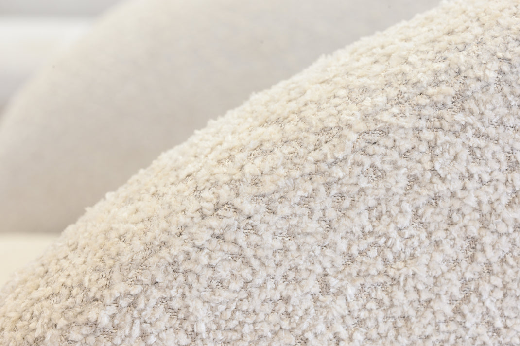 Close-up of a textured cream beige surface of an armchair