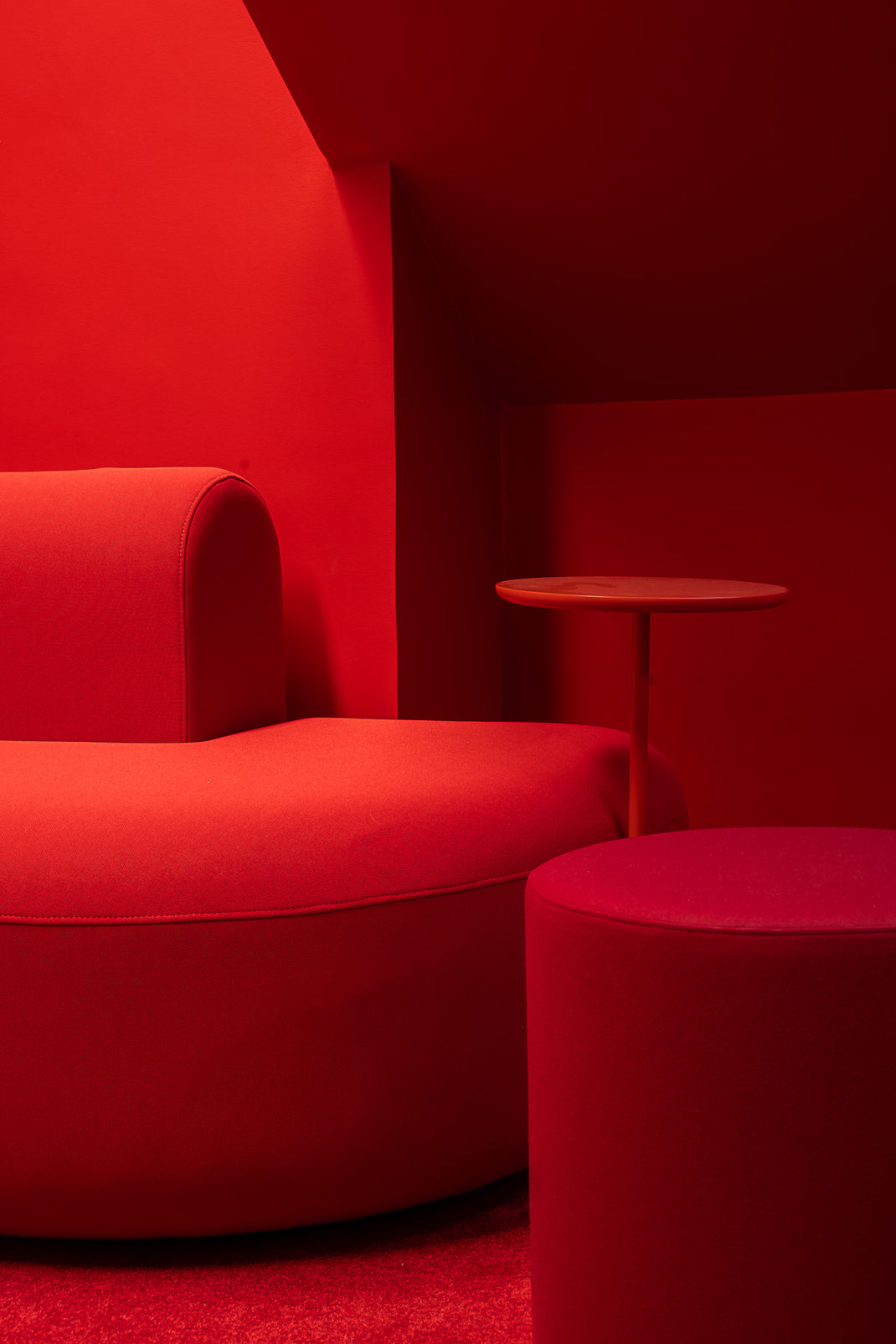 Modern red sofa and chair design in a minimalistic setting