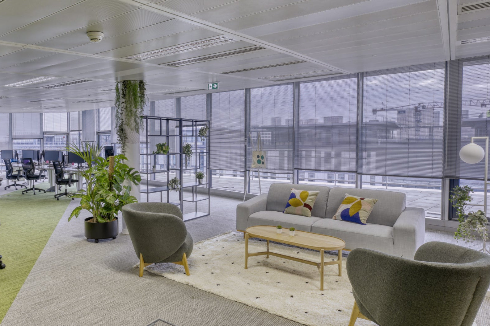 Modern office space with a mix of workstations and lounge area.