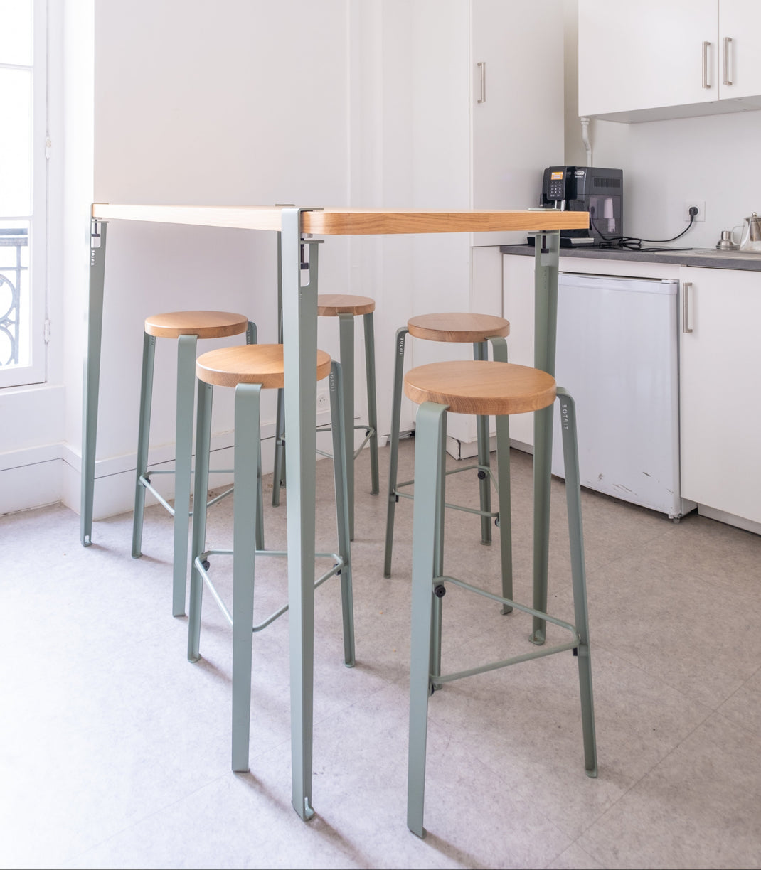 Kitchen with a high table and high stools in a modern setting