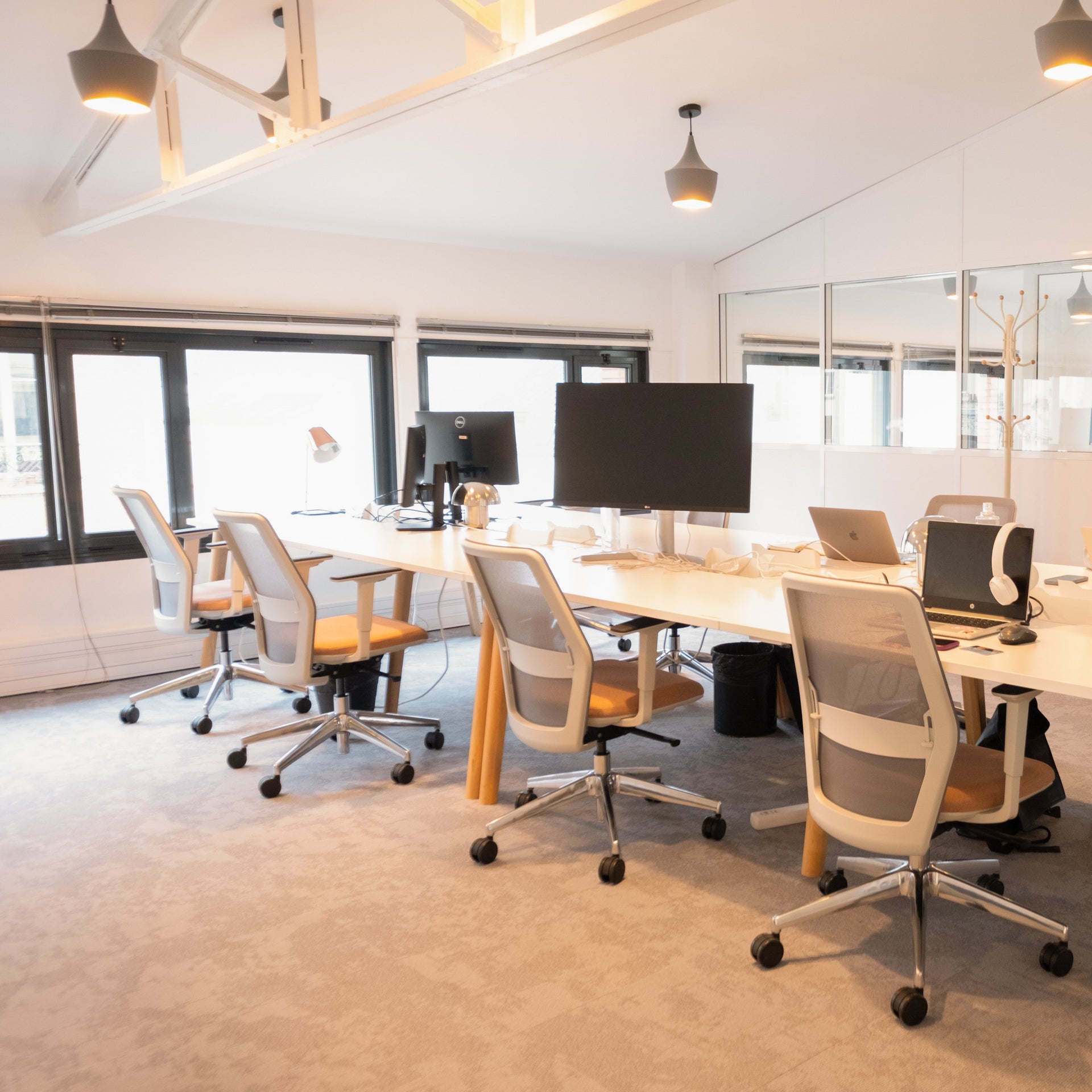 Modern office space with employees working at desks.