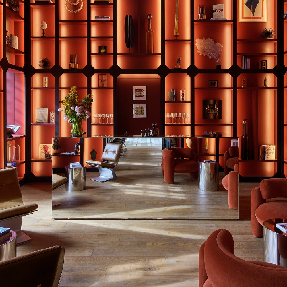 Luxurious interior with orange walls, shelves, and furniture.