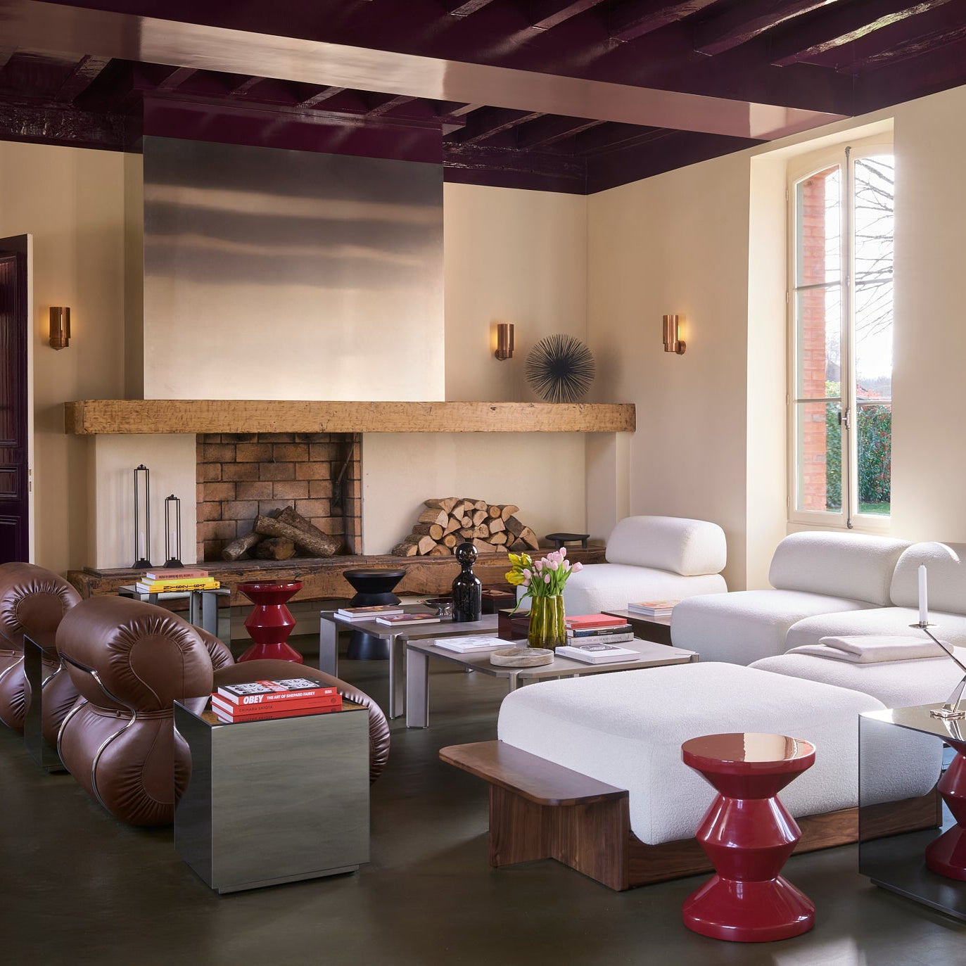 Modern living room with a fireplace, sofa, and decorative items.