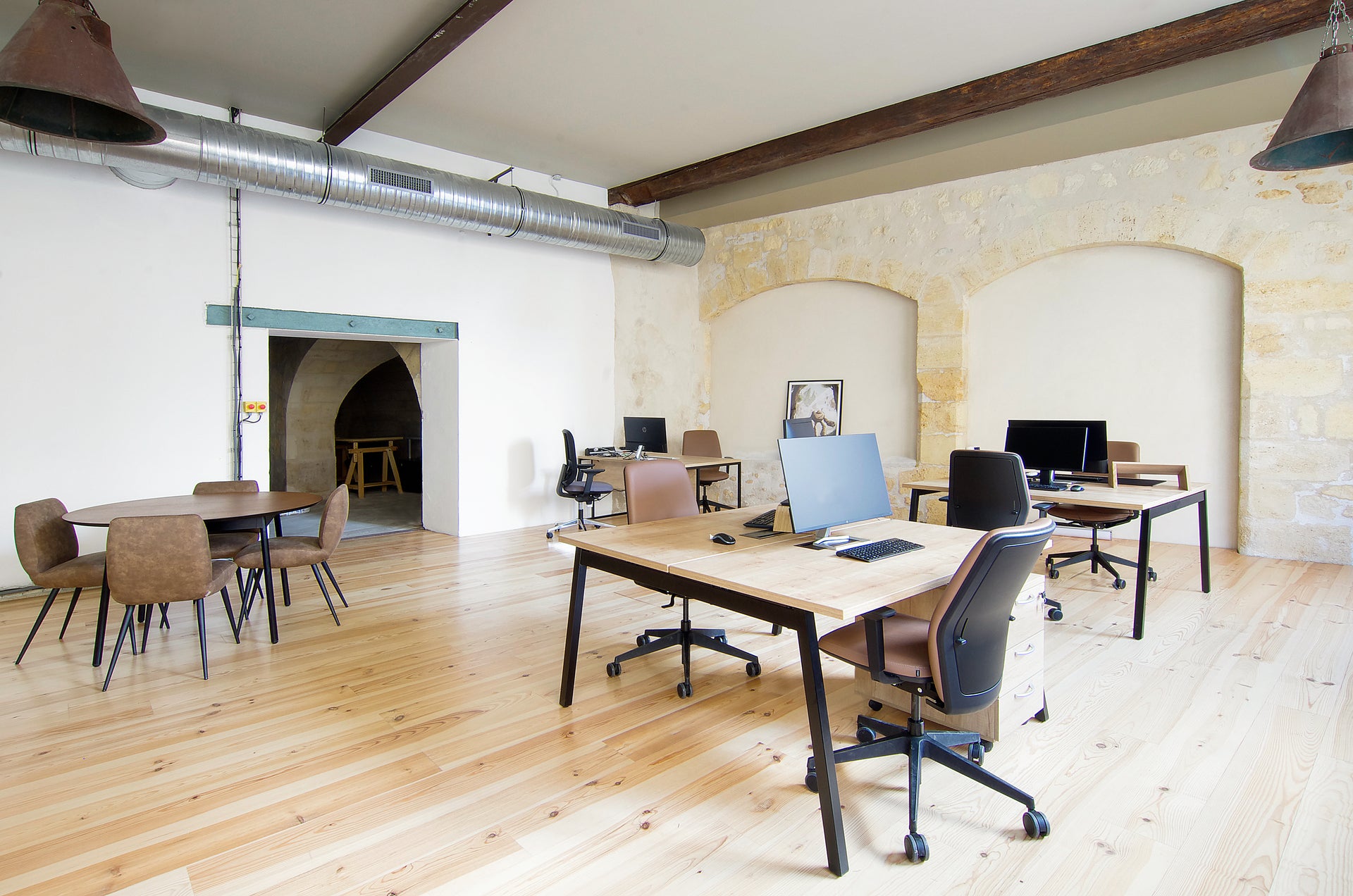 Modern office space with desks, chairs, and computers.