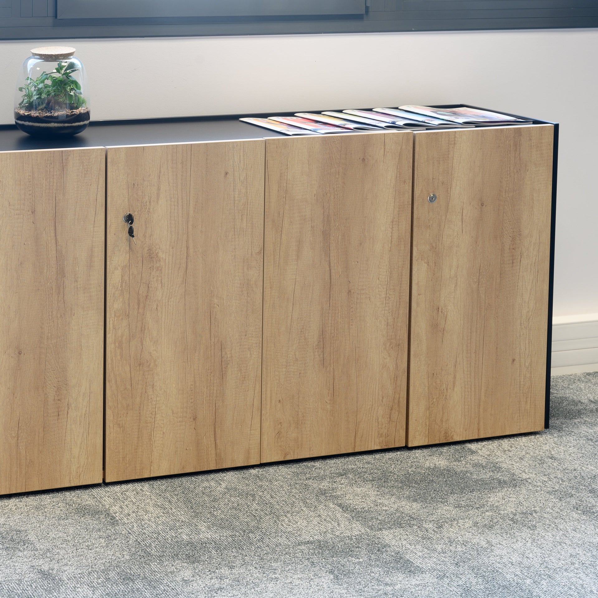 Wooden cabinet with a metallic top in an indoor setting