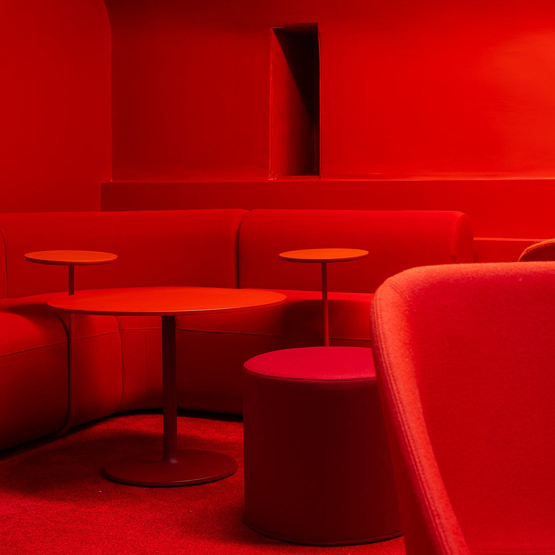 Red interior with chairs and tables in a dimly lit room