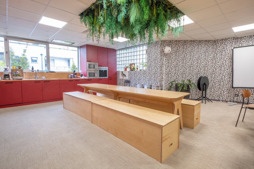 Modern office kitchen with wooden counter and red cabinets