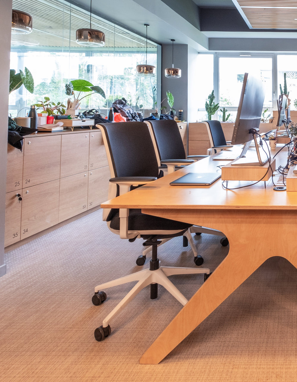 Modern office conference room with wooden table and chairs.