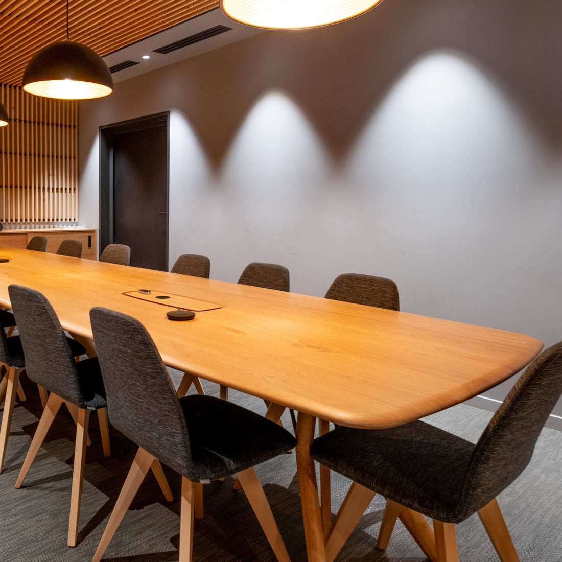 Modern conference room with wooden table and chairs