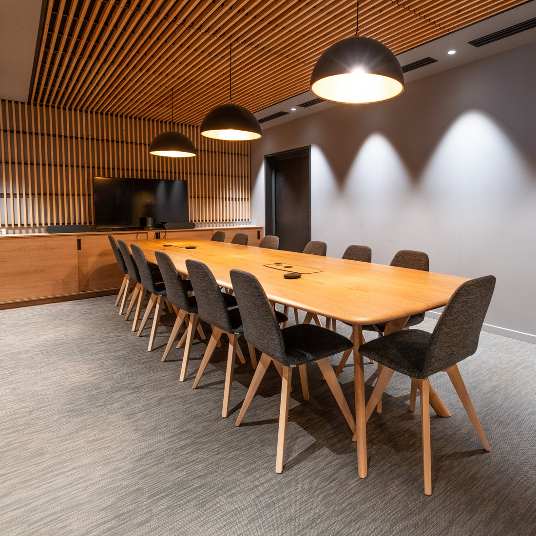 Modern conference room with wooden table and chairs