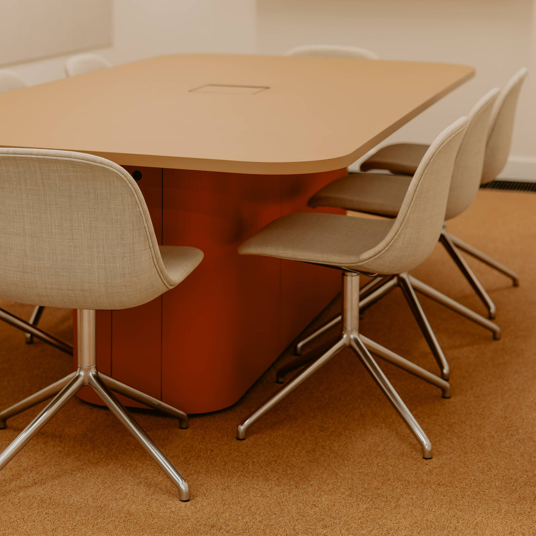 Conference room with a large table and chairs on a brown carpet