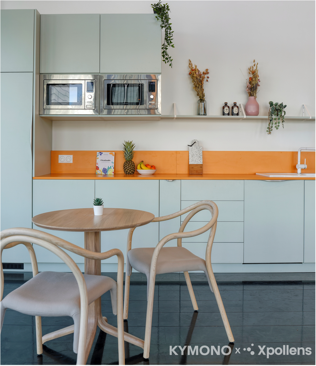 Modern kitchen with a dining area featuring a round table and chairs.
