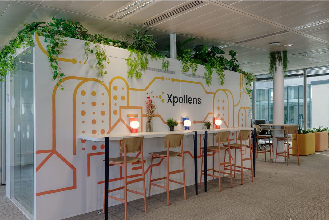 Modern office space with Xpollens branded wall and Kymono decor