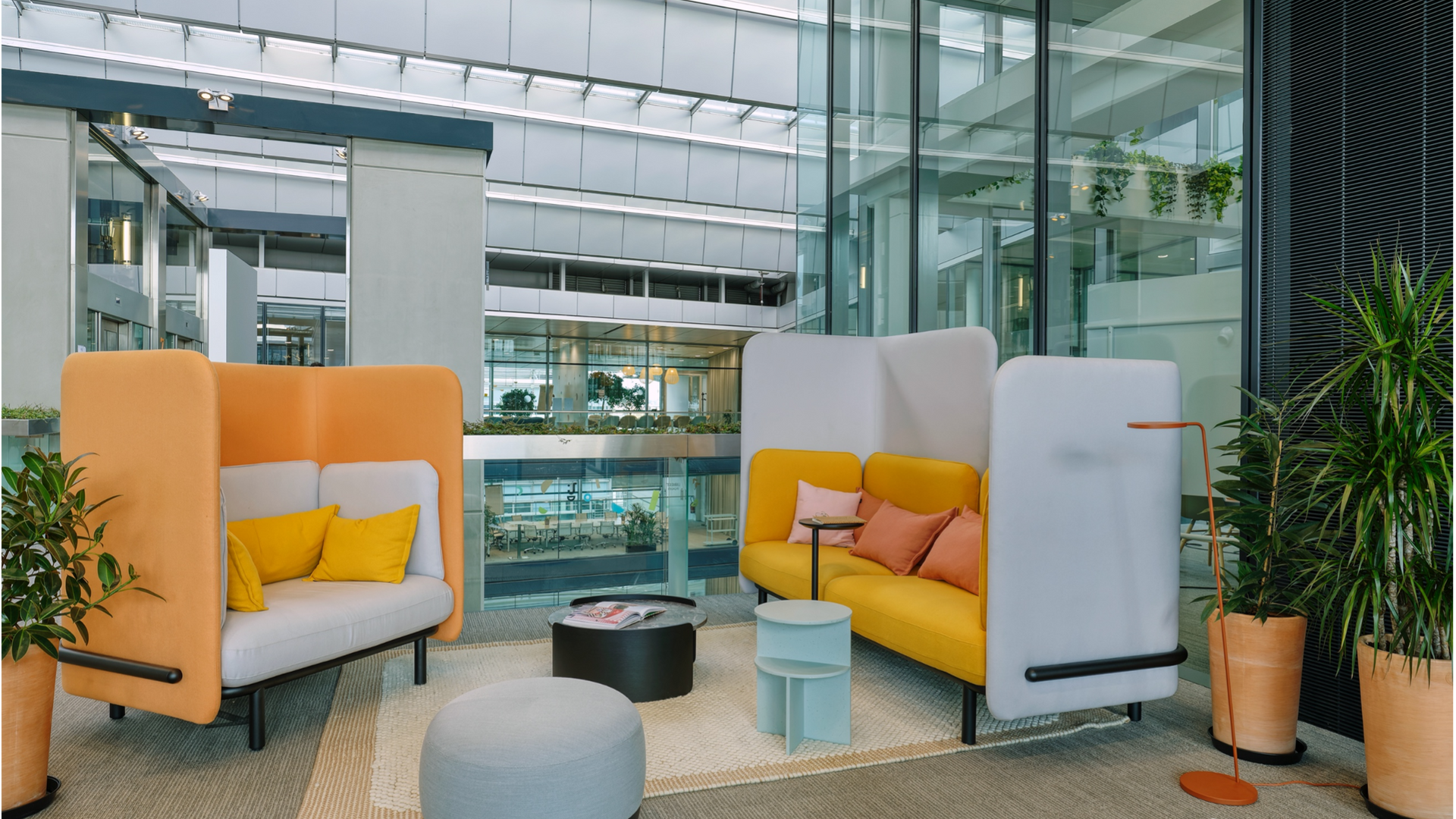Modern office lounge with colorful seating and Xplorlens branding