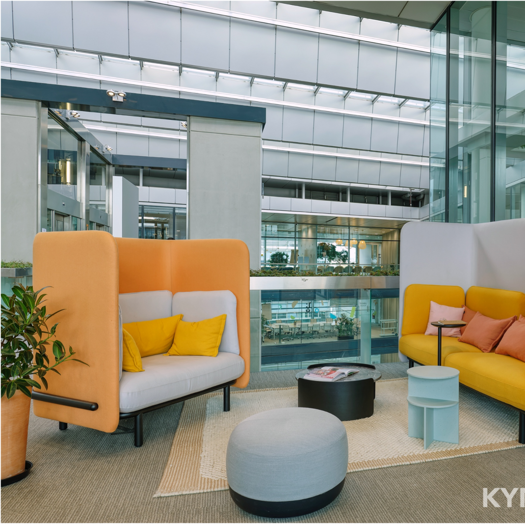Modern office lounge with colorful seating and Xplorlens branding