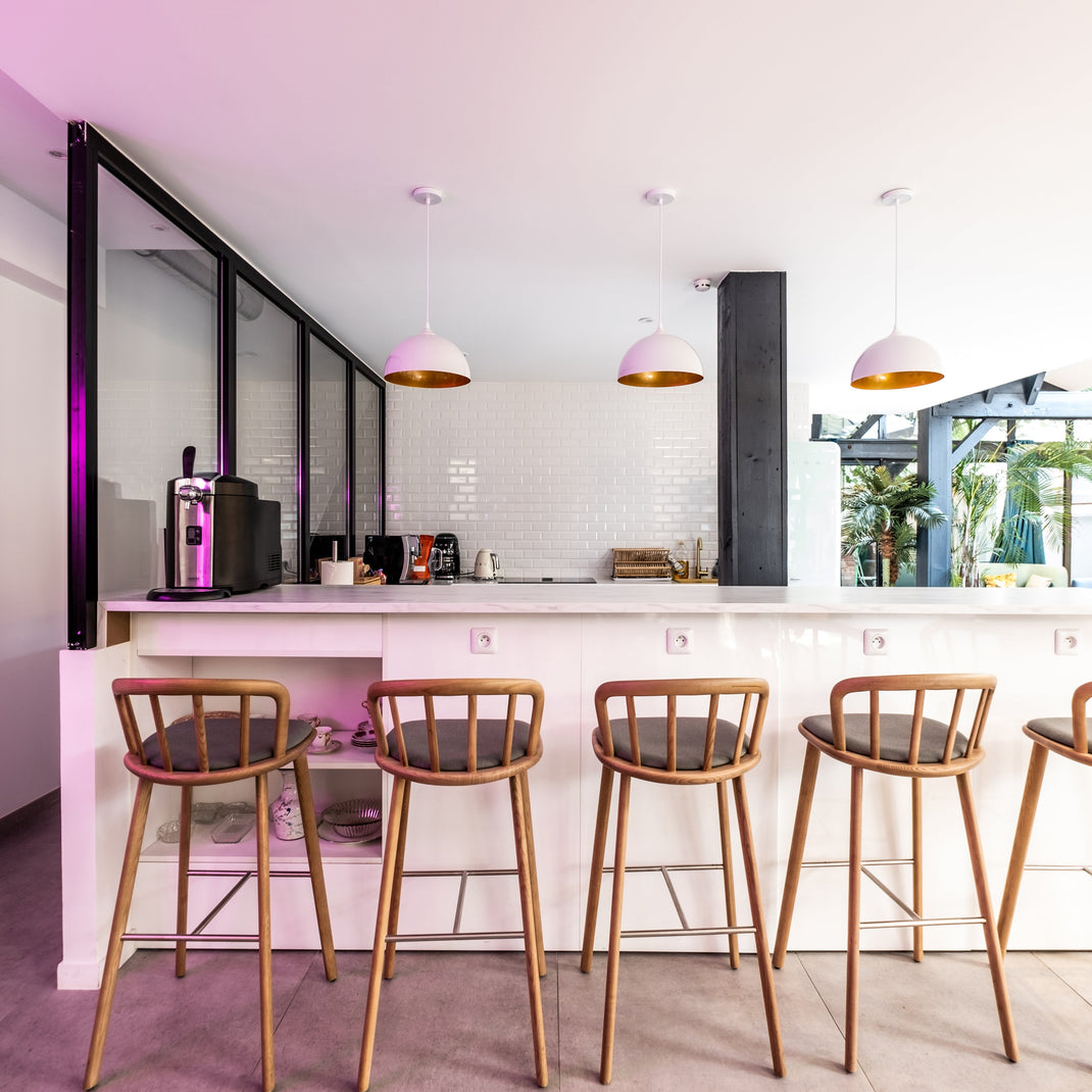 Modern kitchen with bar stools and a white island.